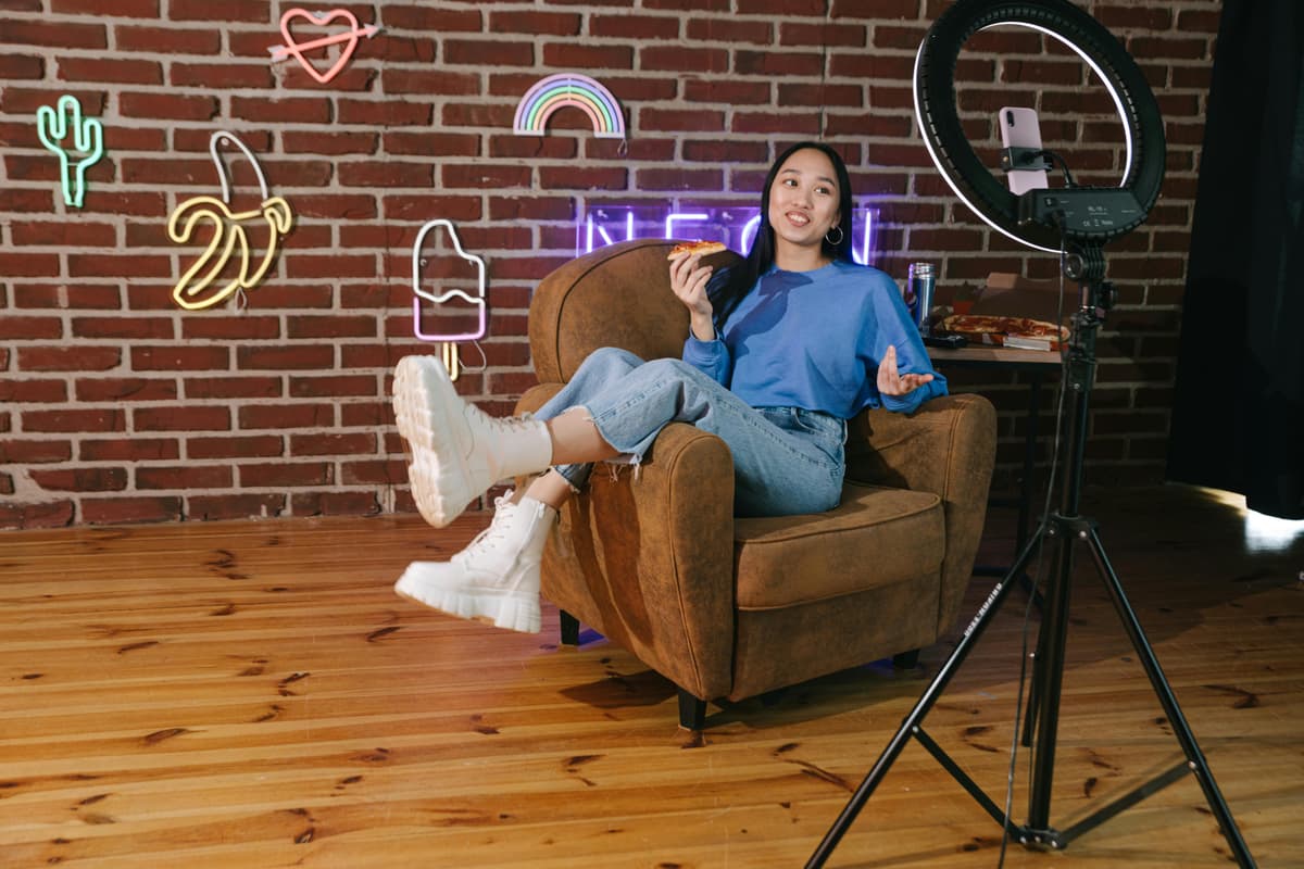 Content creator working with camera and ring light, engaging with audience